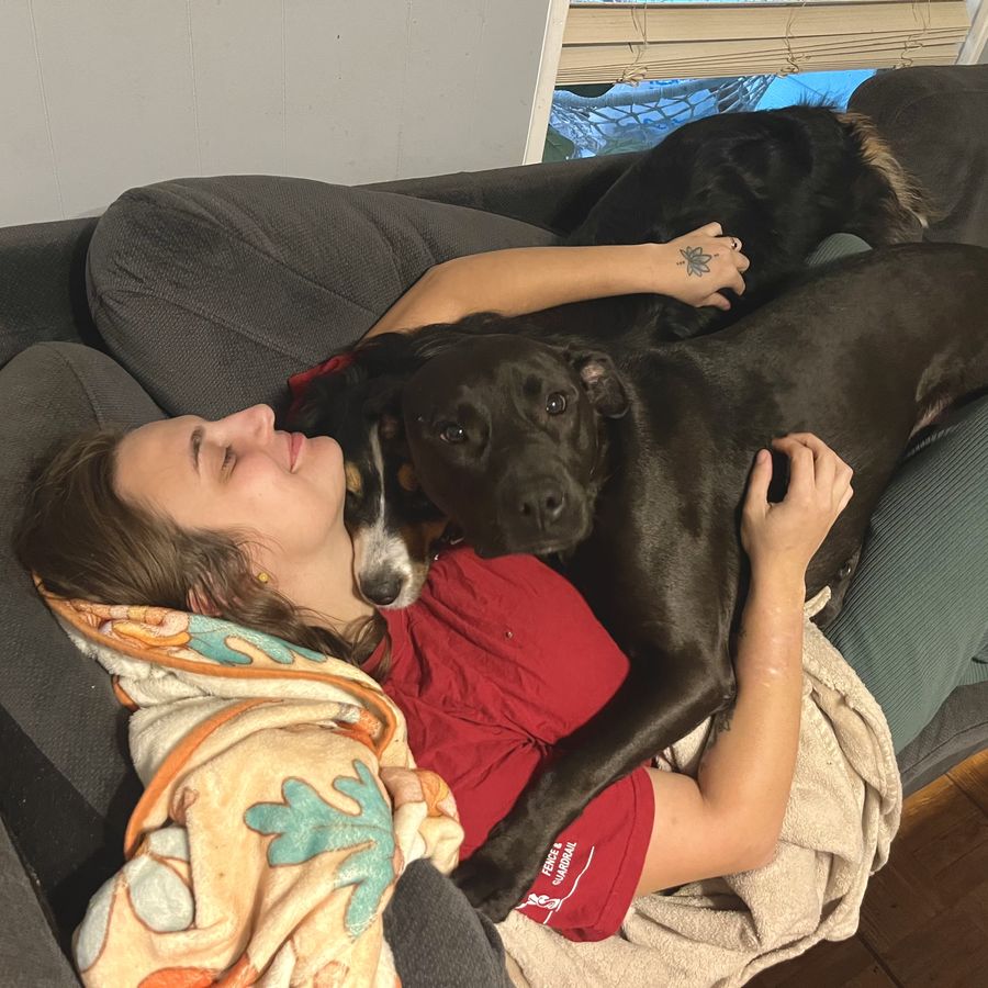 Sully asleep across Grace on the couch